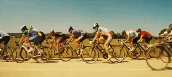 Cyclist riding by other riders